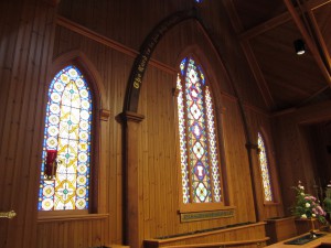 Both the painted arch and the stained glass windows were salvaged and given a place of honor in the new Episcopal Church.