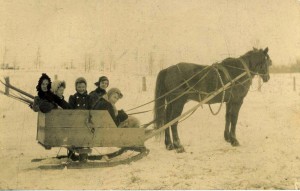 Billy the horse; driving is Jane Shilson, riding with Mabel Wilhelm, Olive Lackey, Claribel Wilhelm and unknown woman.