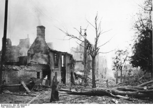 Image of St. Lo after conflict. Image made publicly available by the German Federal Archive, Bundesarchiv, Bild 146-1994-035-17 / Vennemann / CC-BY-SA [CC BY-SA 3.0 de (http://creativecommons.org/licenses/by-sa/3.0/de/deed.en)], via Wikimedia Commons.
