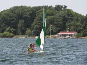 Onekama Sailing Club in August 2014, right. High school juniors Sarah and Katie race to the finish last year, but lost to Bob Beal by one-half of a second.