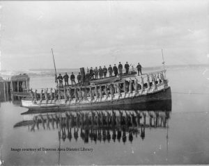 Hunters on the "Onekama" returning from a Upper Peninsula deer hunt trip: L-R: Guy Cox, Jack Smith, Fred Emerson, Leander Muncey, Richard Emerson, Lewis Franklin, J.N. Martinek, Elija Cox, Gus Petander, William Smith, James Mahan, Louis Sleder, Charles Mitchell & Captain Emory, 1898. From the Grand Traverse Pioneer and Historical Society Collection, 873.