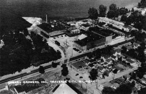 Cherry Growers Canning Company, aerial view from 1947, shows wharf and railroad spur. TADL Historical Society Collection, 3303.